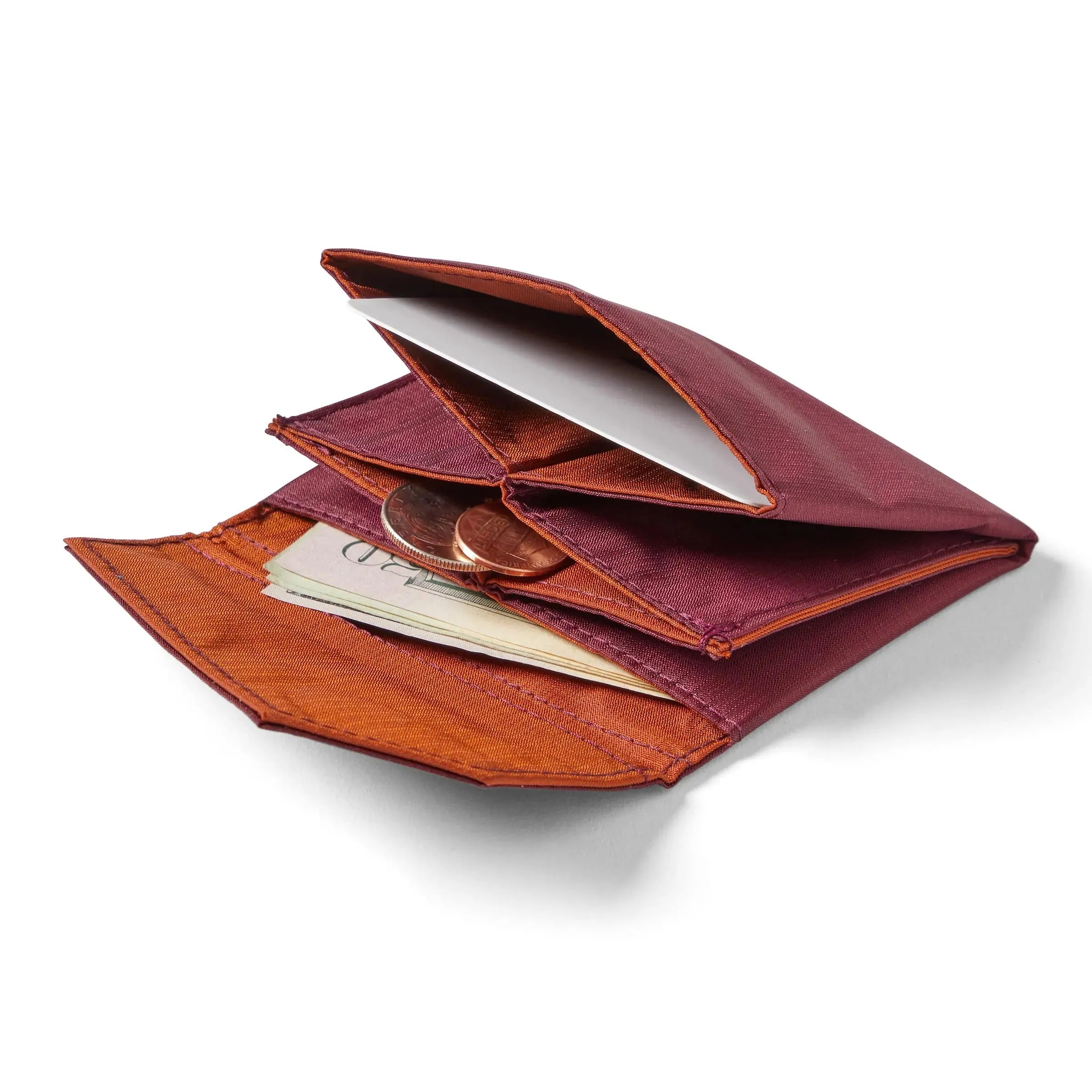 Allett's ripstop nylon premium accordion wallet laying open and flat against a white background, with coins and cash slightly protruding from the interior pockets. Allett Accordion Wallet in RFID Blocking Nylon mulberry