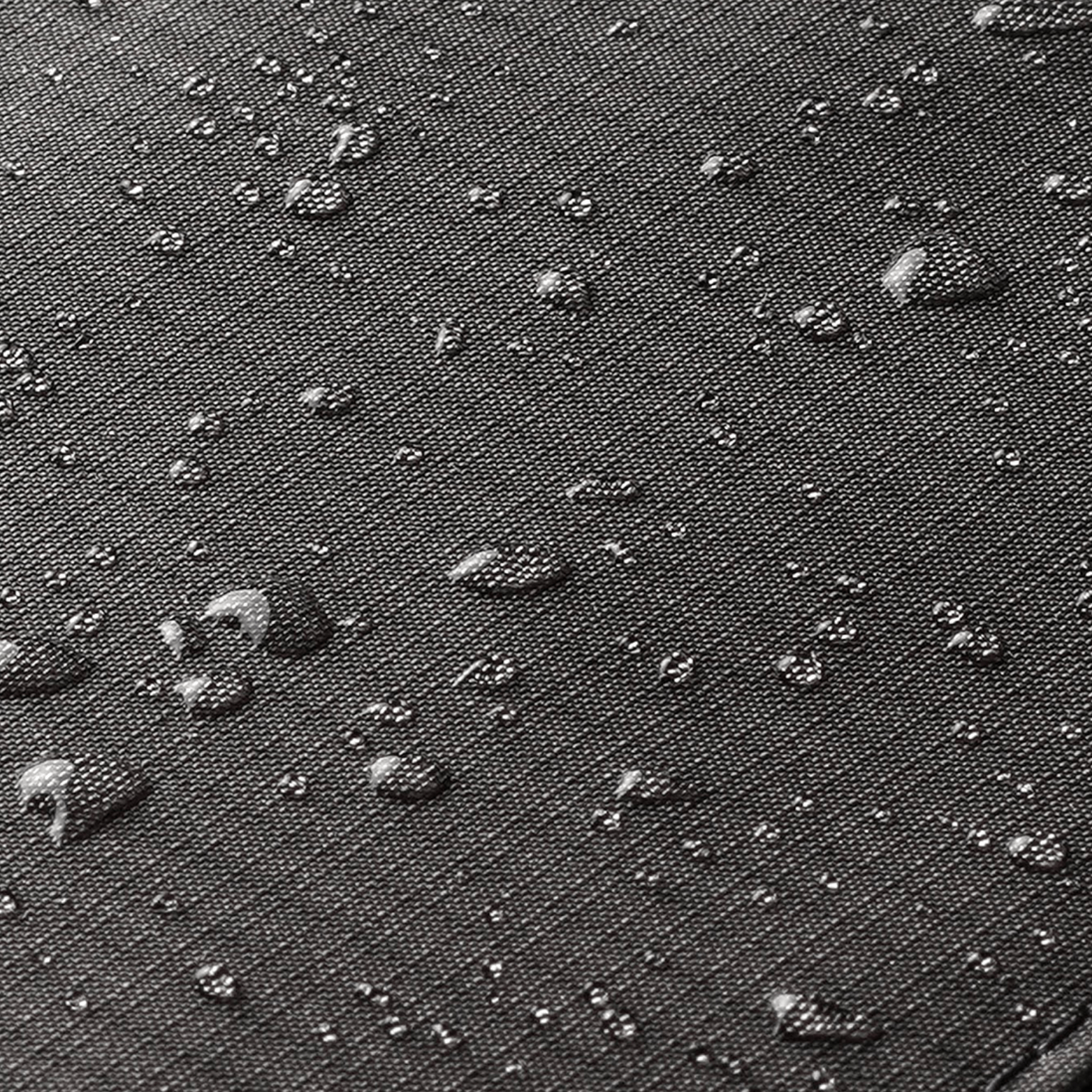 Close-up of water droplets on grey fabric