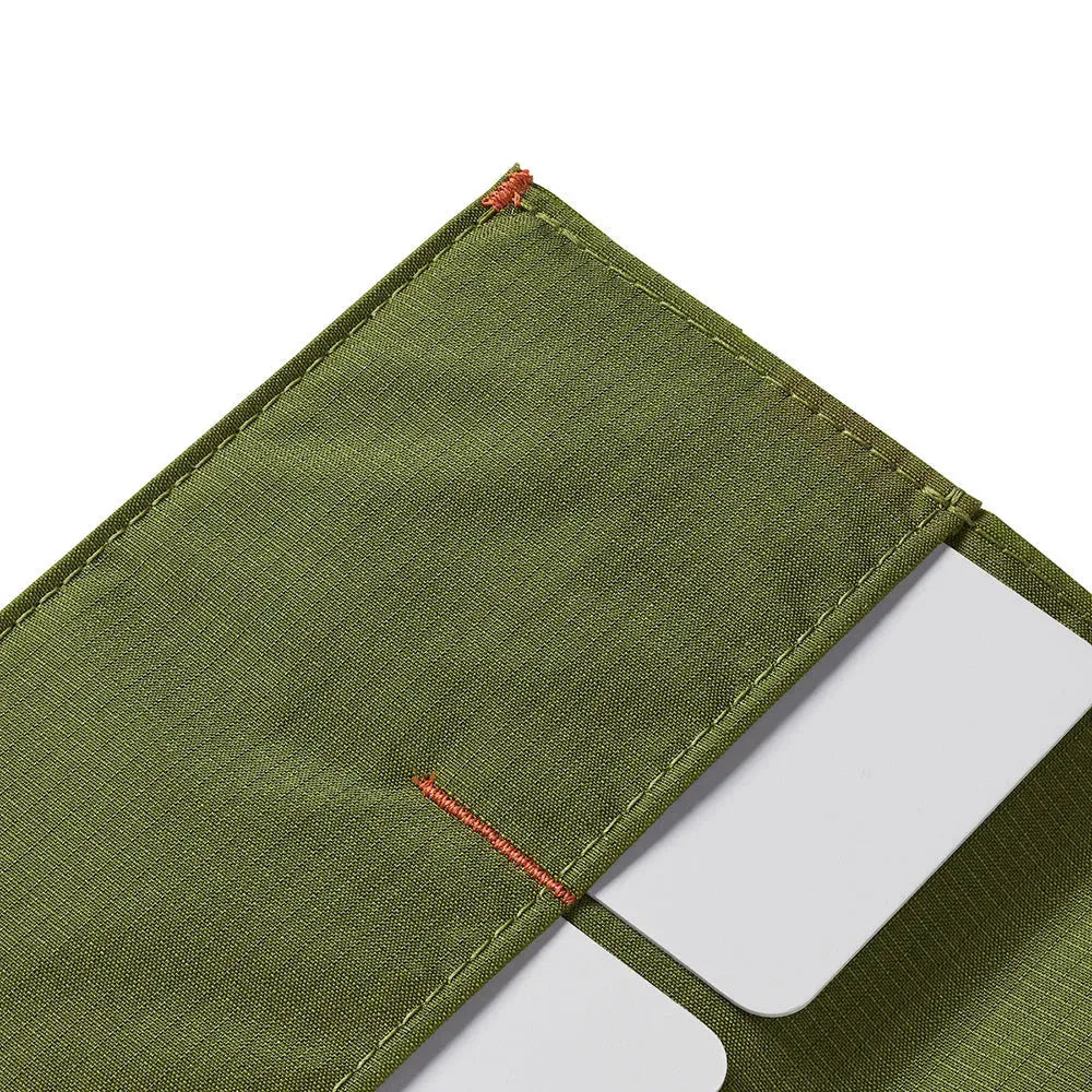 Detailed view of the corner and details of a Allett The Coin RFID blocking minimalist wallet cala-green