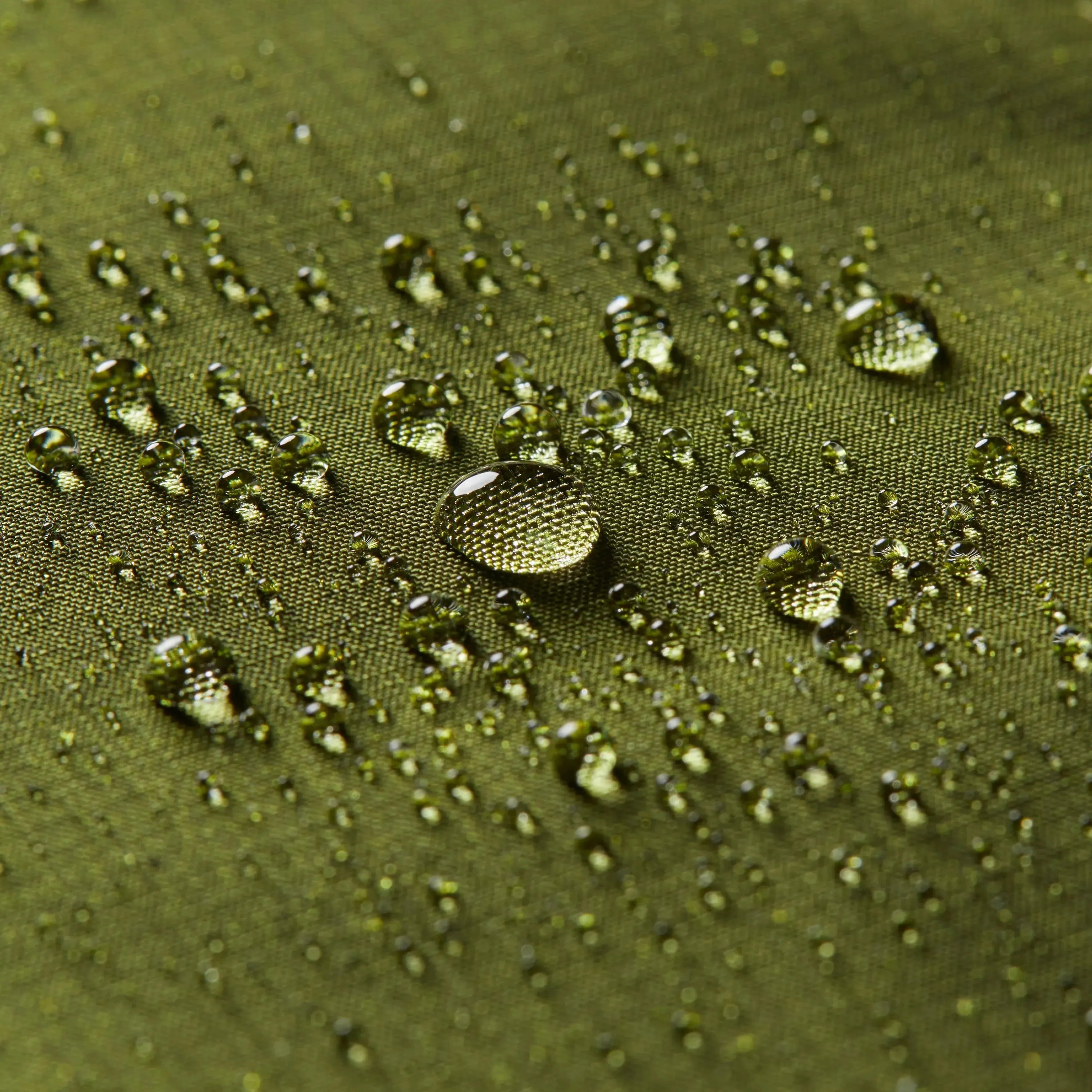 Close up interior of the logo of Allett on the green nylon in the midnight blue leather original wallets with water droplets as a concept to show the water resistance of the fabric. Allett leather original wallet midnight-blue