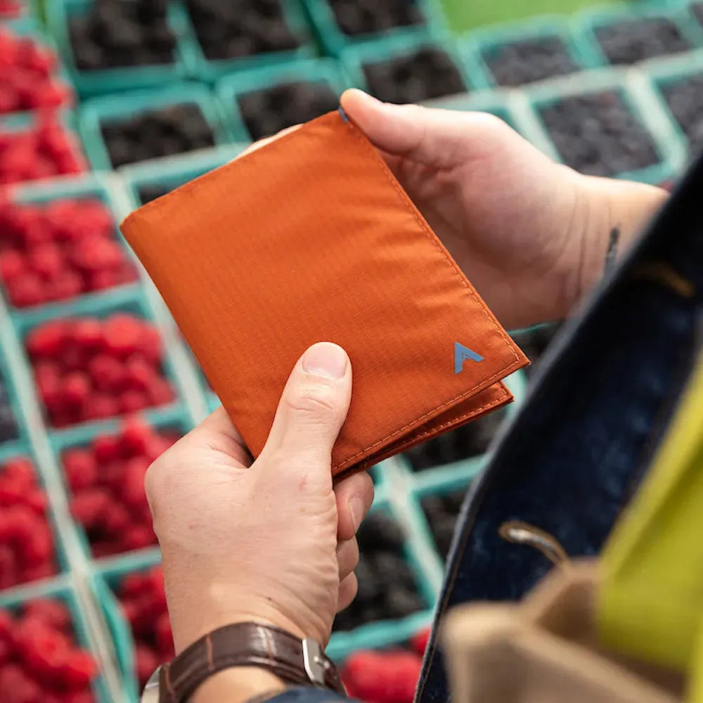 Person holding the ultra slim Allett Original Nylon RFID vegan wallet potters-clay 