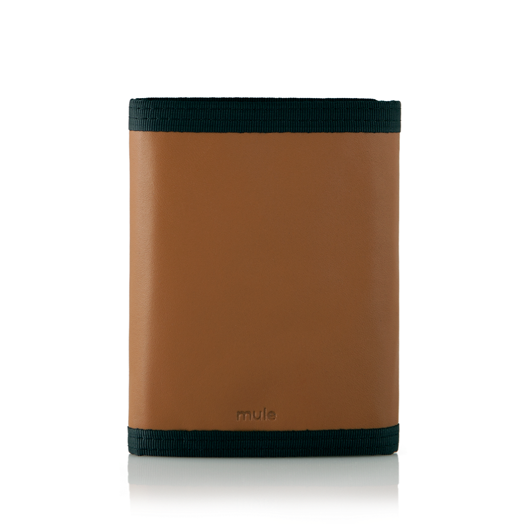 Rear perspective of the brown leather "Switchback" trifold wallet with trim,  securely closed, against a contrasting white backdrop. Allett Switchback Leather Wallet - brown
